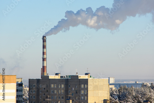 factory chimney fumes over the city