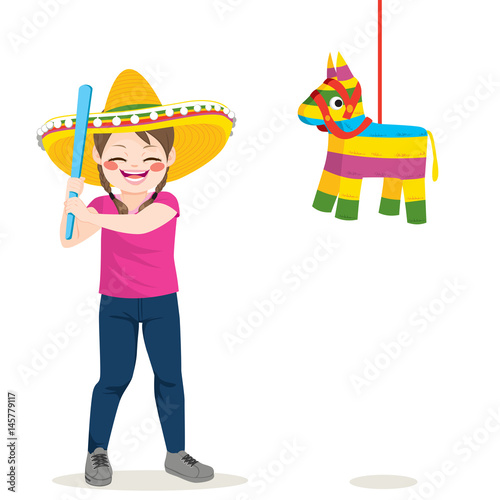 Young little girl holding stick trying to break piñata on 5 de mayo party