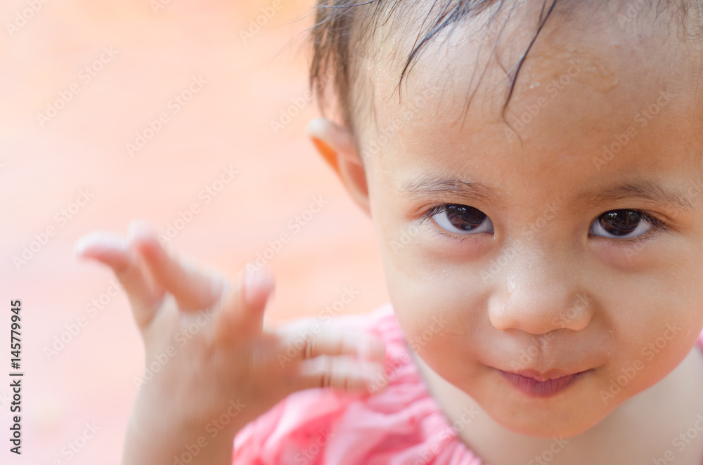 Asian toddler girl with traditional thai costumes enjoy splashing water during Thailand Water Festival (Songkran Day) Asian toddler girl with traditional thai costumes enjoy splashing water during Thailand Water Festival (Songkran Day)