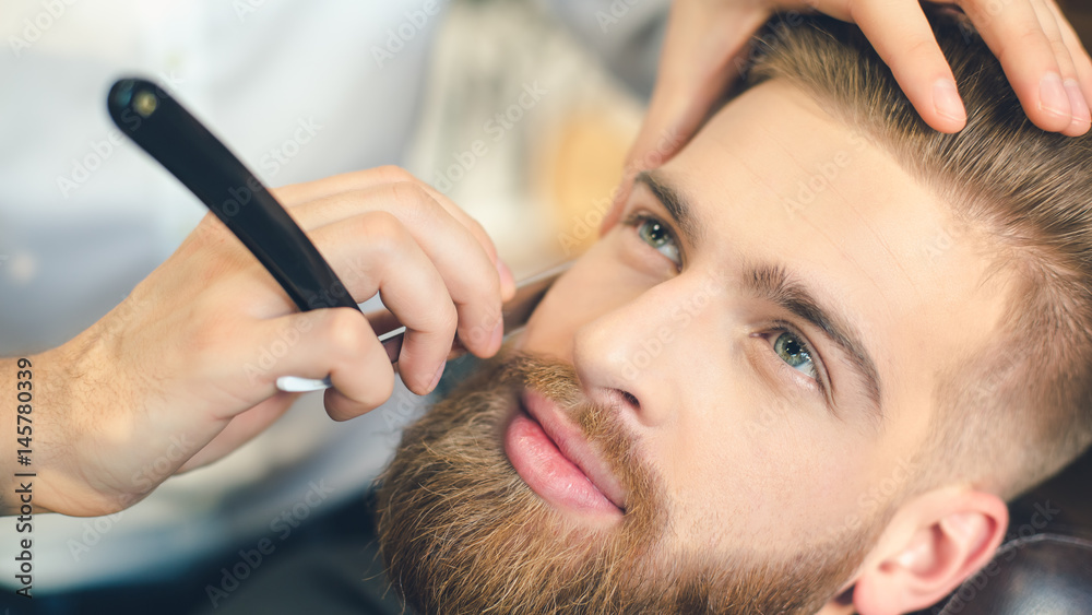 Young Man in Barbershop Hair Care Service Concept Young Man in Barbershop Hair Care Service Concept