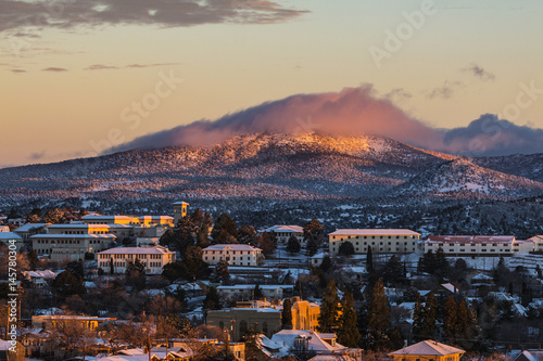 Small mountain town college lightly covered with snow at sunset