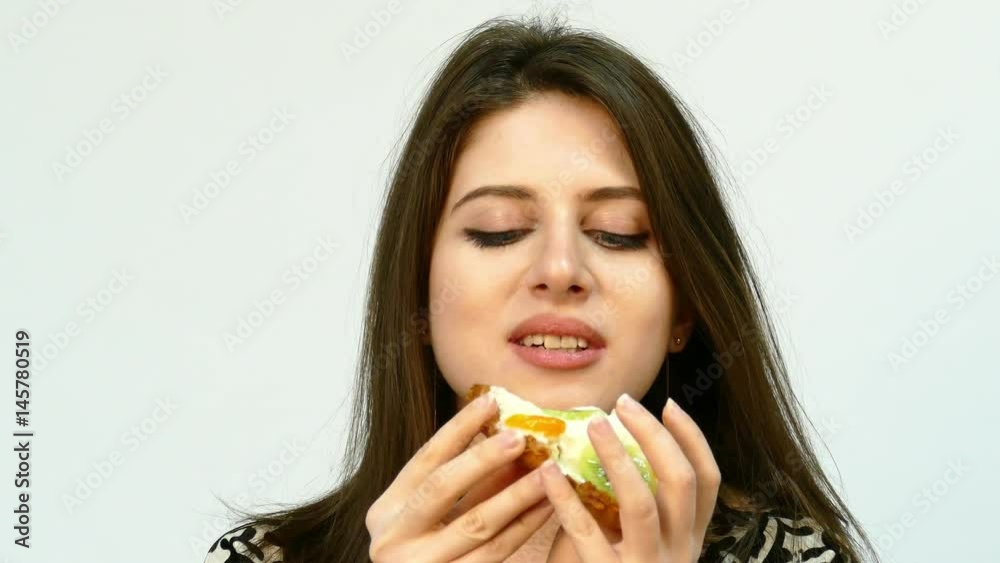 Young brunette Woman Eating the Cake Young brunette Woman Eating the Cake