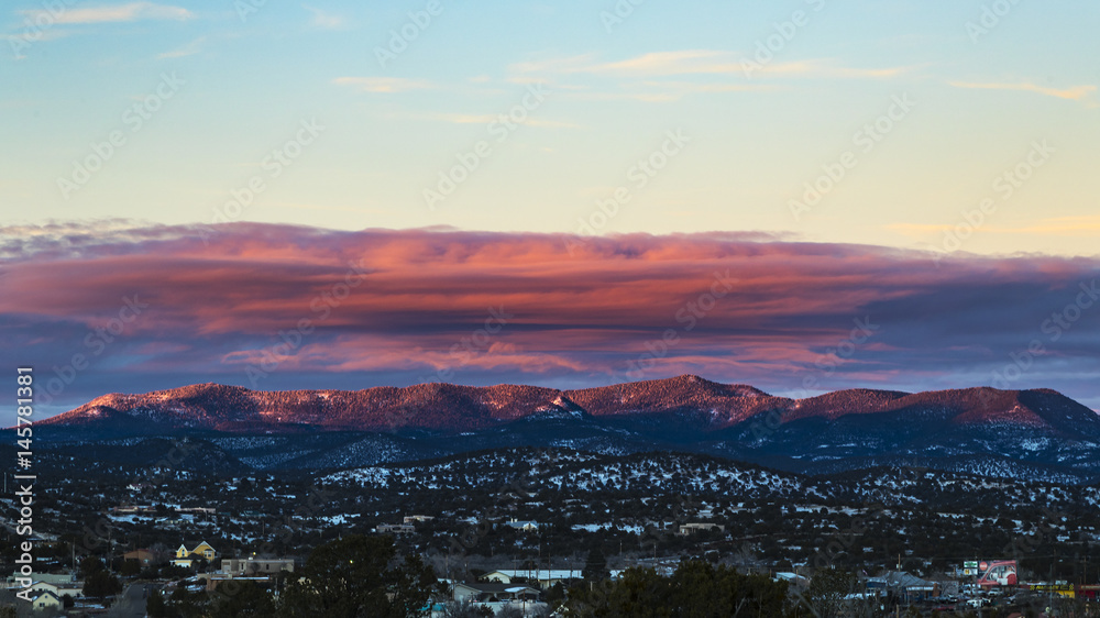 sunset over mountain range with slight dusting of snow sunset over mountain range with slight dusting of snow