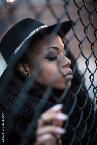 A portrait of a young, black woman, posing in the streets of Brooklyn, New York City.