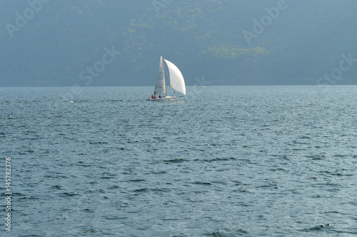 Sailboat in the lake. Lake Como. White sail