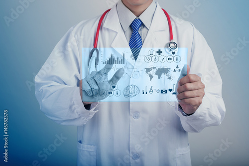 Medicine doctor hand holding stethoscope and working with modern medical icons