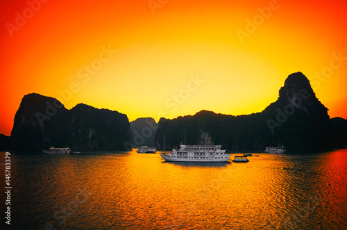 Sunrise and ruise boats on Halong bay, Vietnam photo