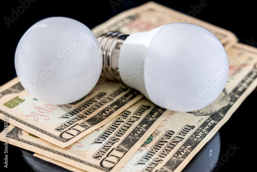 led bulb with usa money isolated on a white background