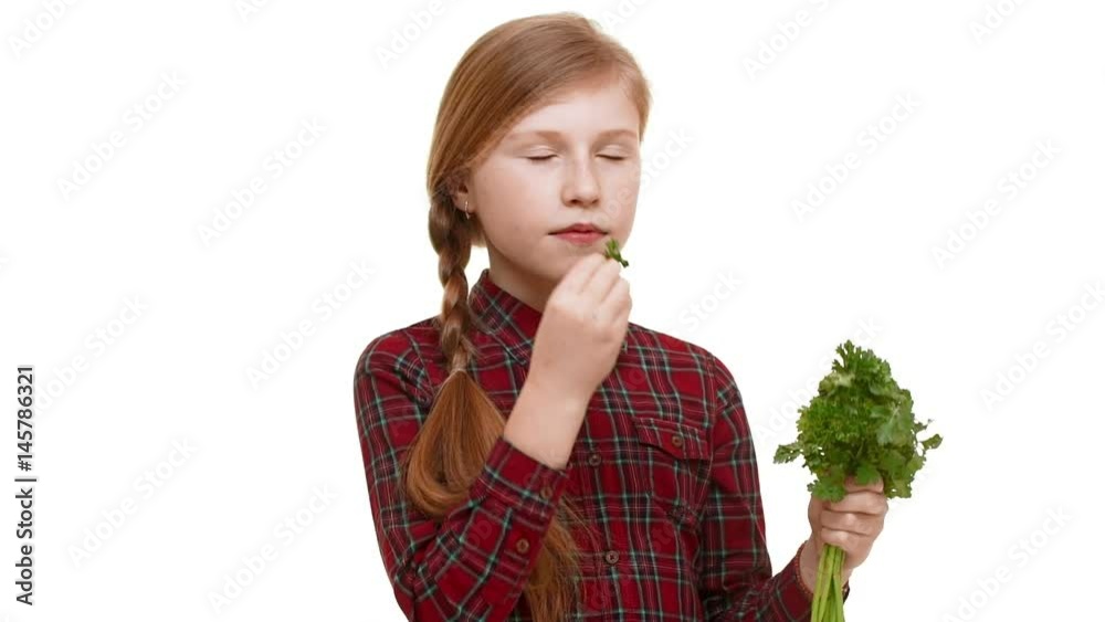 Young lovely Caucasian girl with plait og hair holding bunch of greenery and smelling with pleasure small piece of it in slowmotion Young lovely Caucasian girl with plait og hair holding bunch of greenery and smelling with pleasure small piece of it in slowmotion