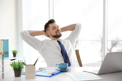 Relaxed young man sitting a...