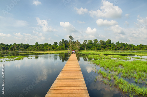The wooden path towards to Neak Pean temple on artificial island. Angkor.