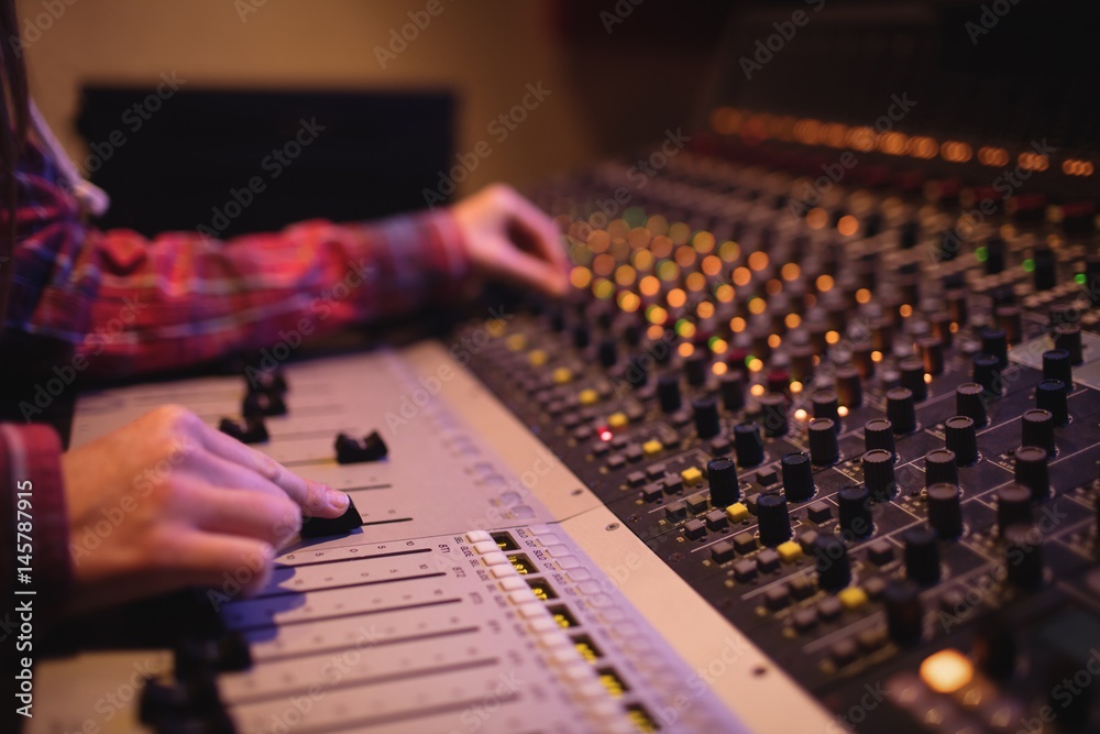 © Wavebreak Media - Hands of female audio engineer using sound mixer