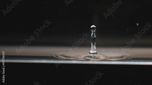 Drop of liquid causes ripples, slow motion
