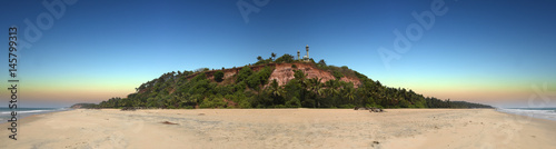 panoramic view of red colored stones cliff with mosque on top in Varkala, Kerala, India  © hnphotography