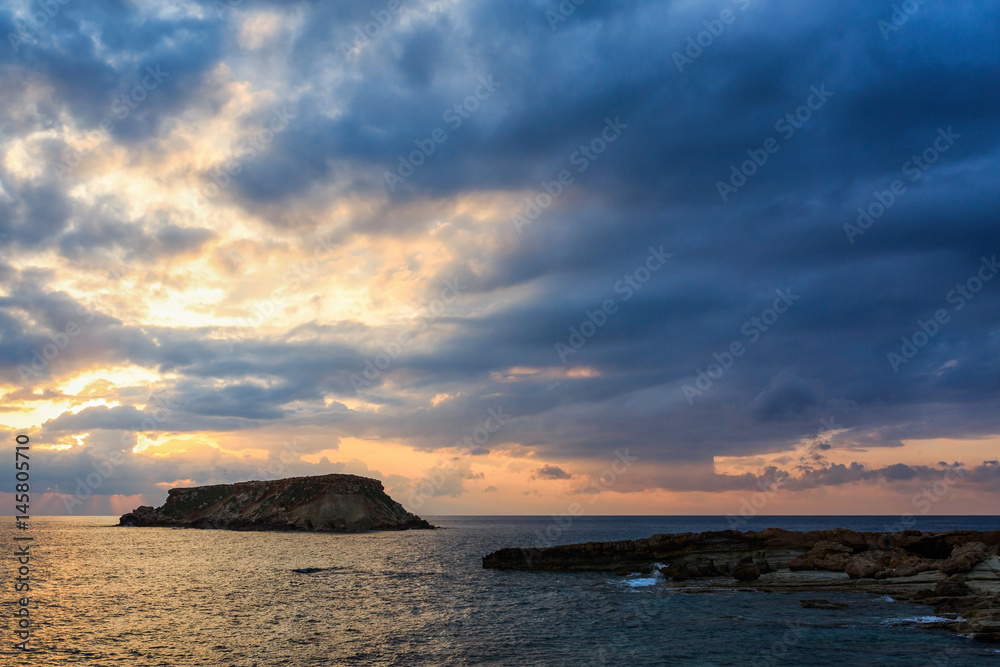 Yeronisos island at sunset next to the Ayios Georgios archaeological area, Pegeia, Cyprus.