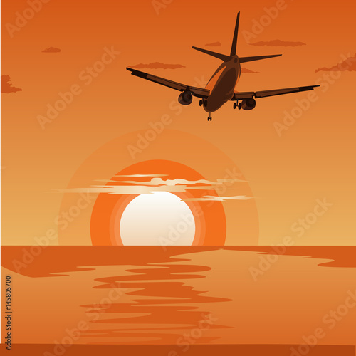 Commercial airplane flying above tropical sea at sunset