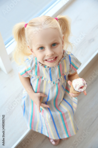 Cute little girl sitting on...
