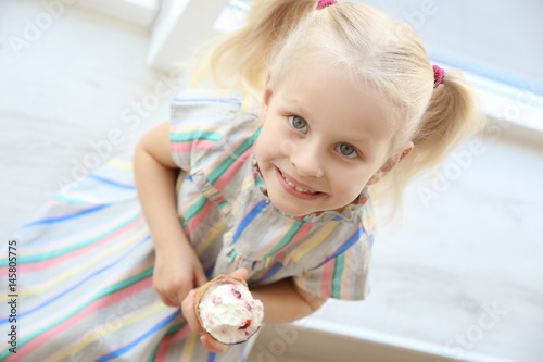 Cute little girl sitting on...