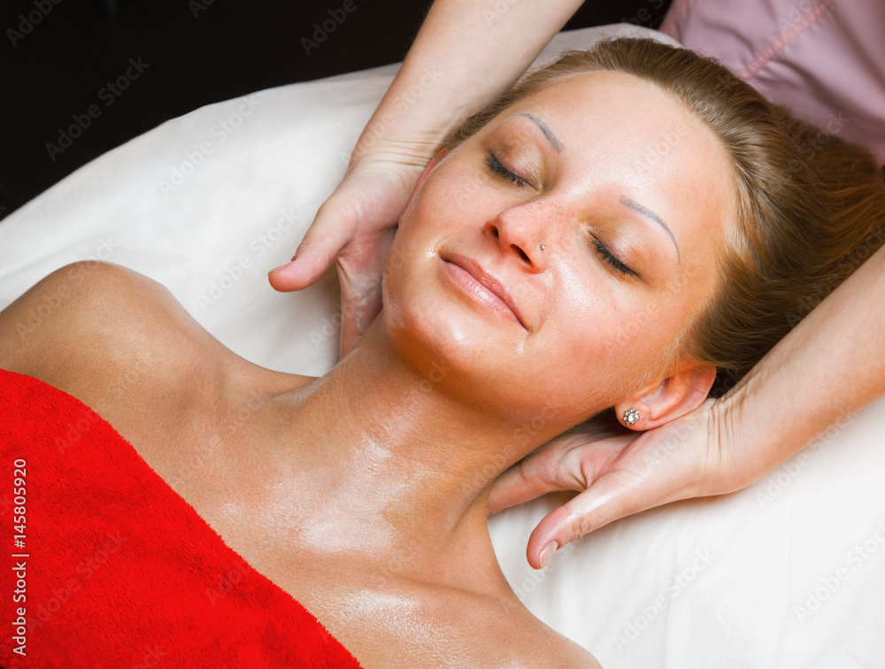 Beautiful woman receiving a neck massage