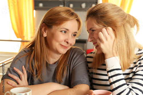 Happy young woman and her m...