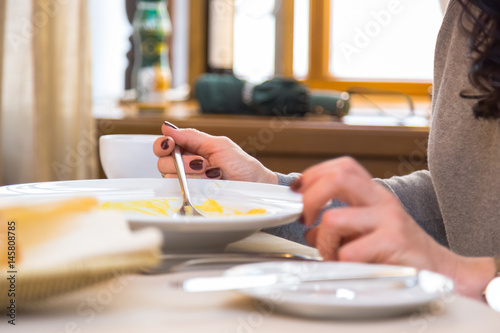 Woman diet eating porridge at a table in a restaurant