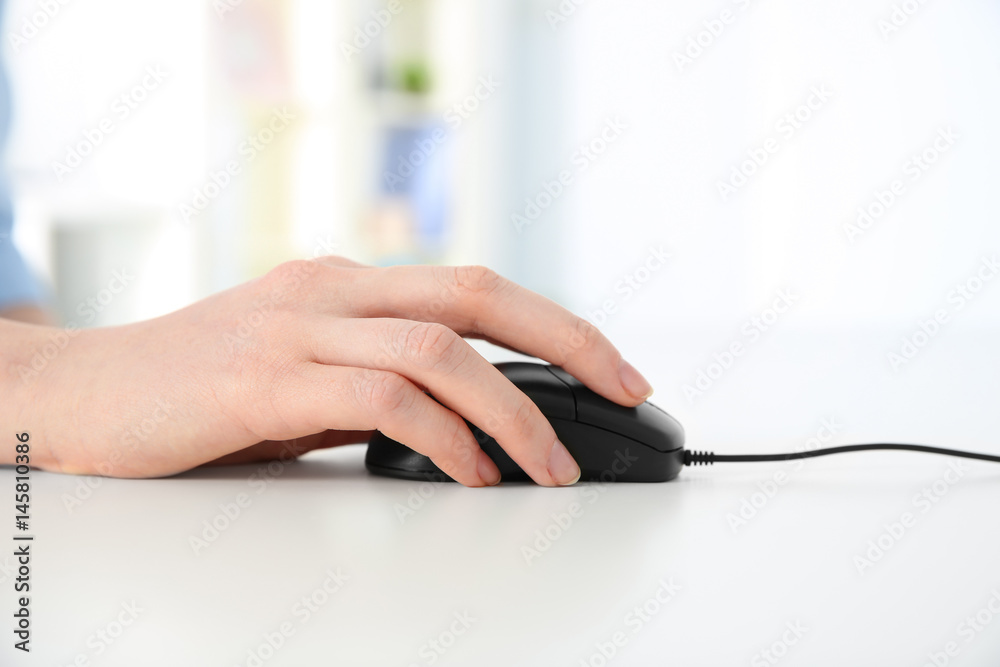 Hand of woman working with computer mouse in office Hand of woman working with computer mouse in office