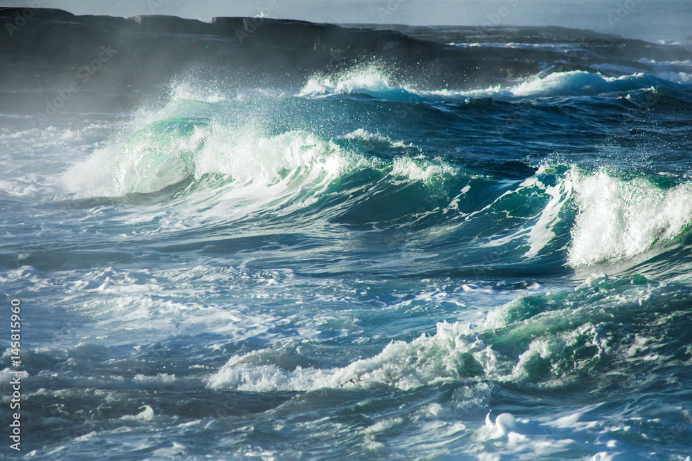 Fototapeta premium Big stormy ocean wave. Blue water background