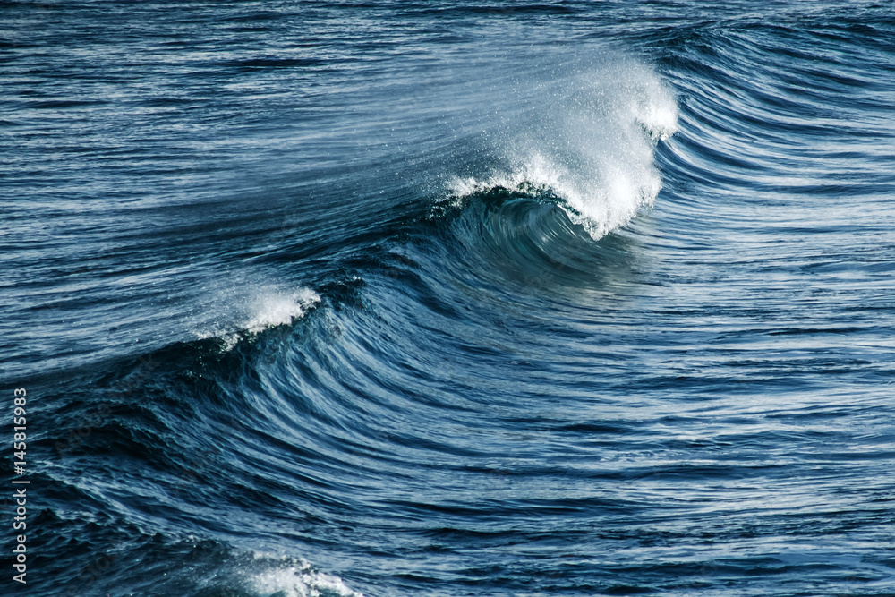 Big stormy ocean wave. Blue water background Big stormy ocean wave. Blue water background