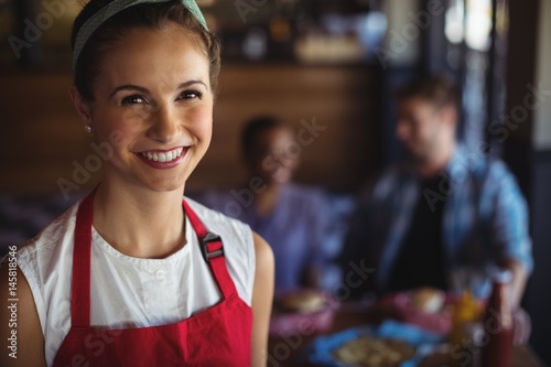 Smiling waitress at restaurant photo