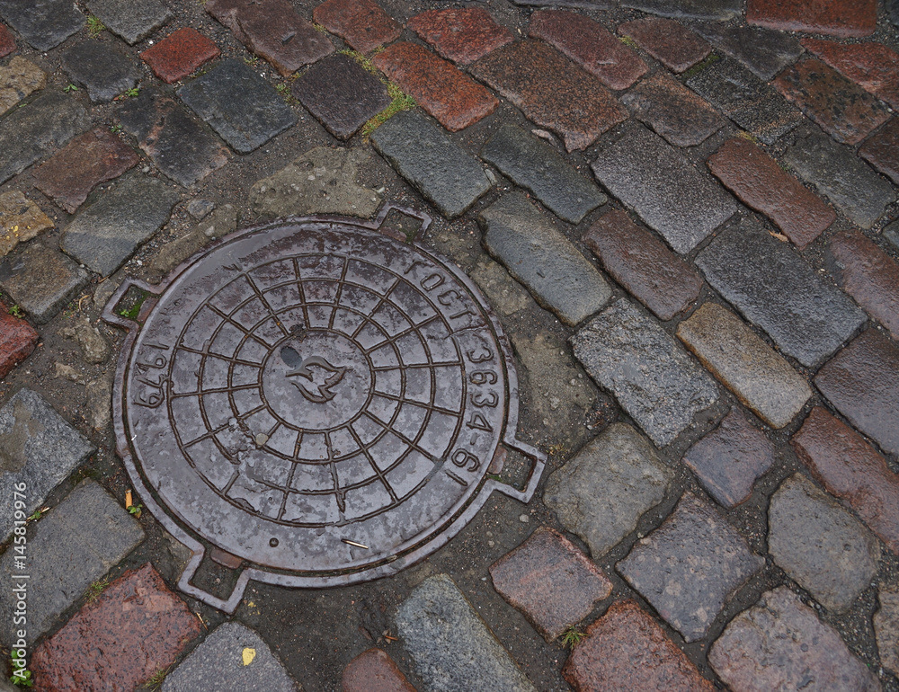 Hatches city sewer. Manhole covers. Round cast-iron lid. Metal cover of storm sewage