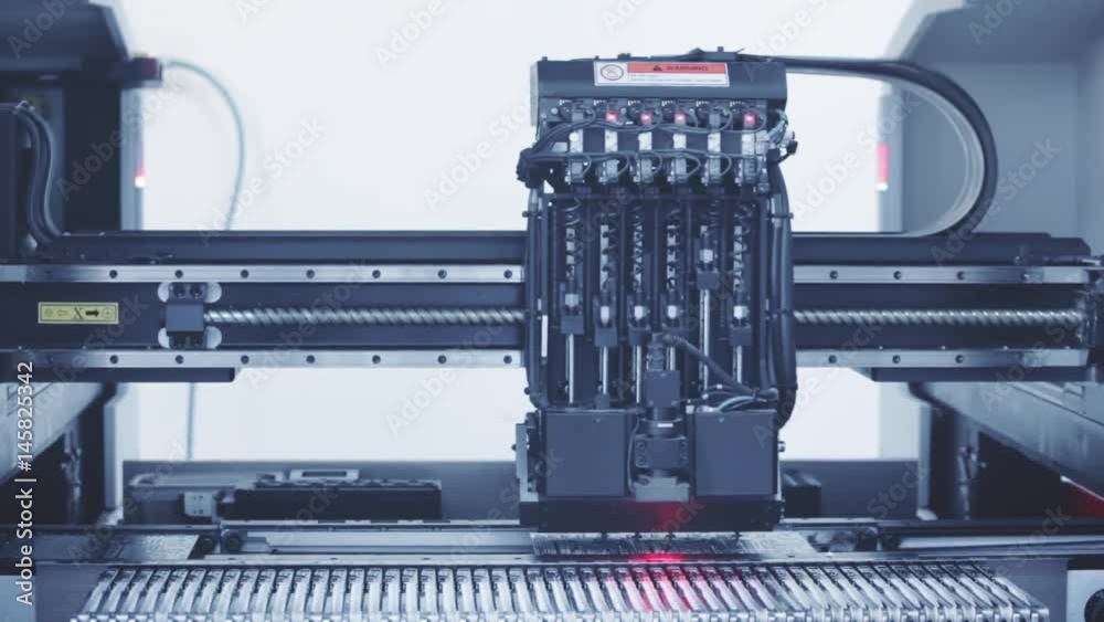 Automated Electronic circuit board production close up. Machine Produces Printed digital board, contract manufacturing. Manufacture of electronic chips. Robotic arm. High-tech. Full HD. Blue toning