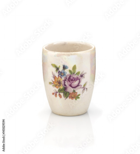 Old ceramic vase with a pattern on a white background