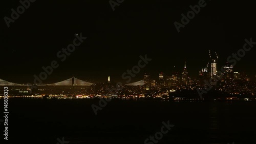 View of the night city in the lights and the luminous bridge photo