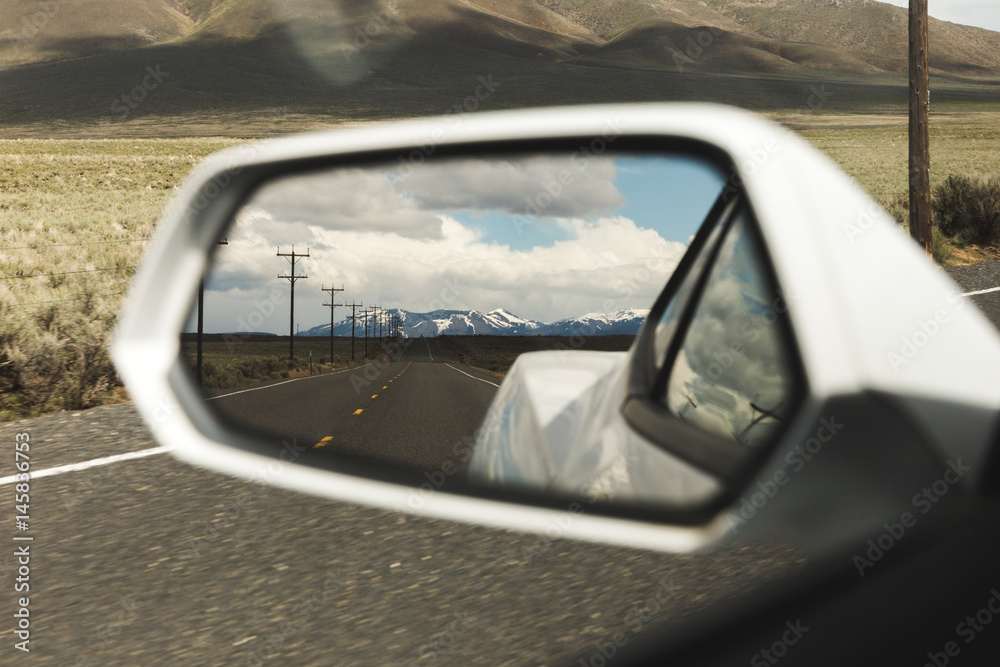 Mountains in Side Mirror View on Sports Car