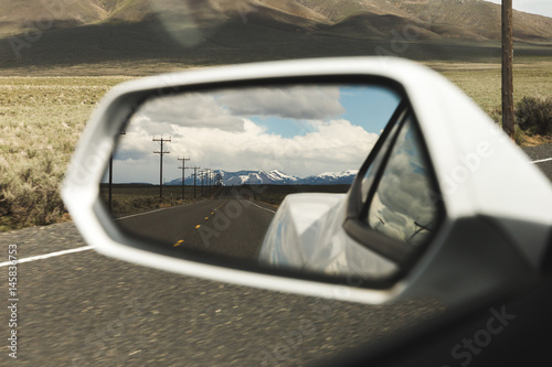 Mountains in Side Mirror View on Sports Car photo