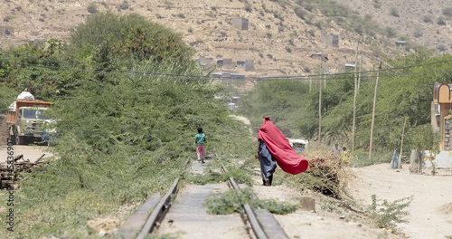 People walk in desert town in Ethiopia near Somalia photo