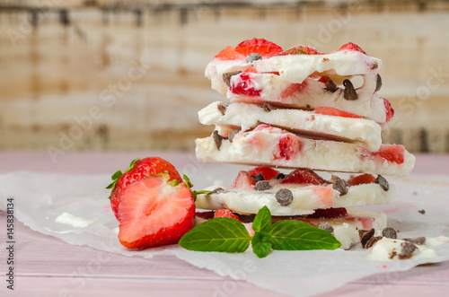 Homemade healthy frozen strawberry yogurt bark. photo