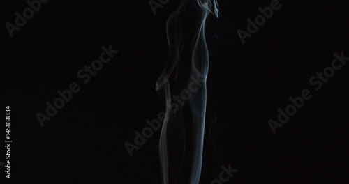 Magical wisps of smoke rise from bottom of frame as if from candle or fire