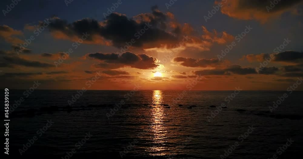 Brightly colored sunset over the calm Mediterranean Sea. Drone Point of View . Night Brightly colored sunset over the calm Mediterranean Sea. Drone Point of View . Night