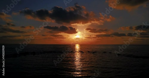 Brightly colored sunset over the calm Mediterranean Sea. Drone Point of View . Night	