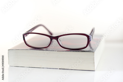 Education,Book and glasses on white background