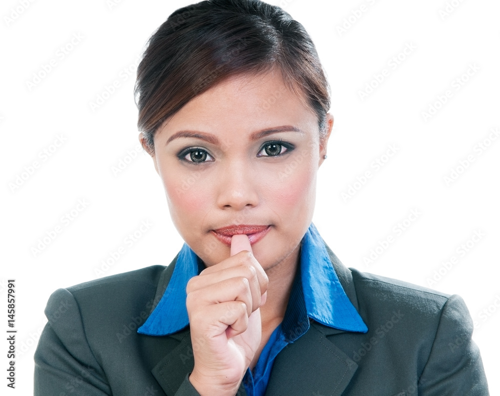 Close-up portrait of young corporate woman sucking thumb over white background Close-up portrait of young corporate woman sucking thumb over white background