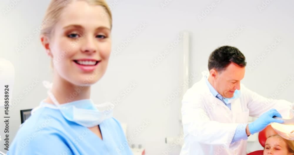 Portrait of smiling nurse standing in clinic Portrait of smiling nurse standing in clinic