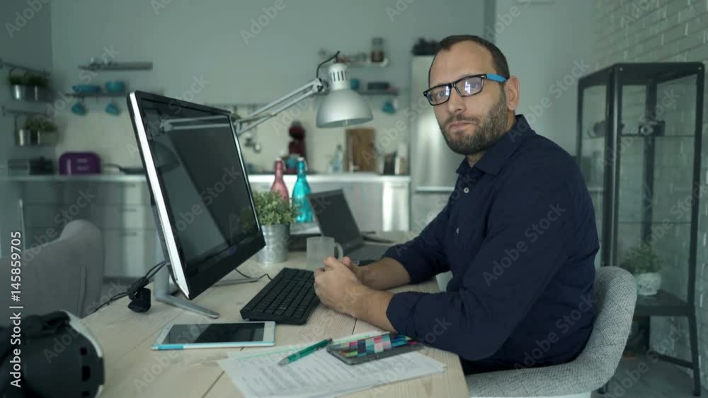 Portrait of serious man looking at camera sitting by table at home
Portrait of serious man looking at camera sitting by table at home