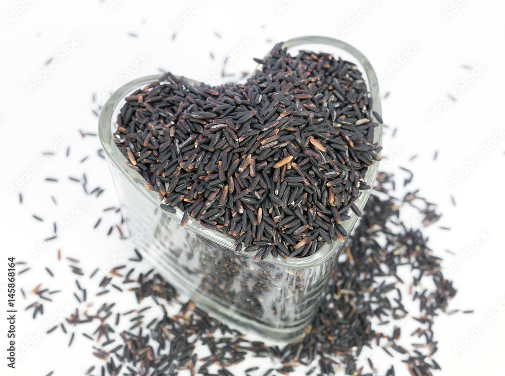 Fototapeta premium Rice-berry in heart shape glasses on white background