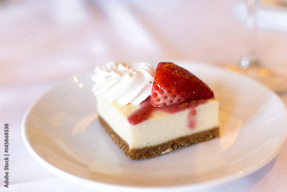 Cheesecake with cream and strawberry on the plate Cheesecake with cream and strawberry on the plate