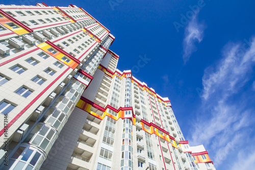 The facade of the new residential high-rise buildings against the sky . The concept of building a typical residential neighborhood