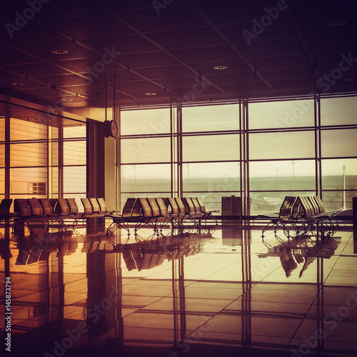 Silhouette of empty airport terminal during sunrise. Travel Concept. Vintage colors