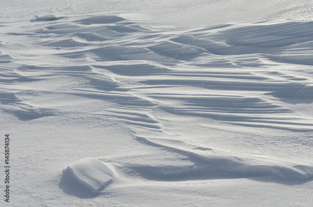 Naklejka premium Snow like waves frozen from the winter winds.