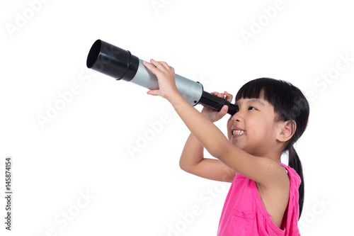 Asian Chinese little girl looking through a telescope